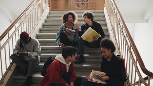 Students Sitting on the Stairs at School