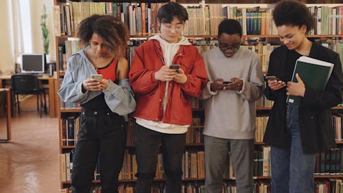 People Using Cellphone at the Library