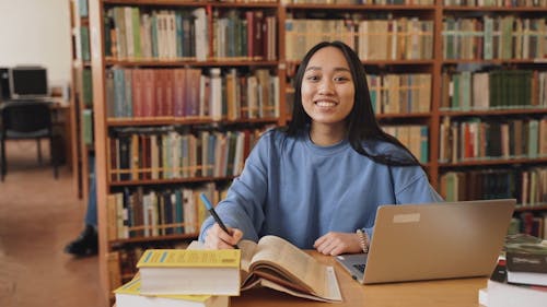 A Woman Smiling While Looking at a Camera