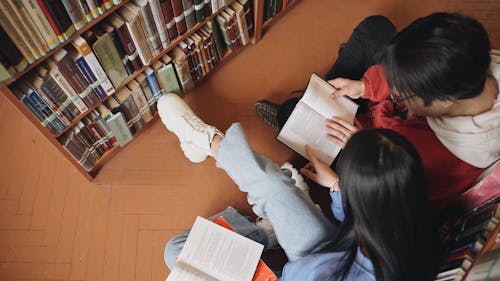 Students Reading Books In The Library