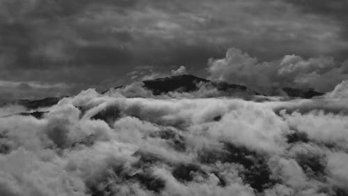 Mountain Peak among Moving Clouds 