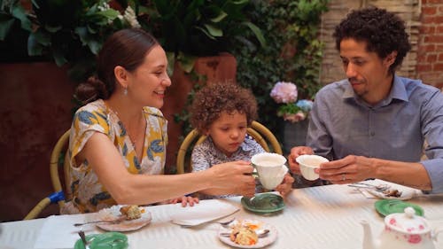 A Family Drinking Milk While Having Breakfast Together