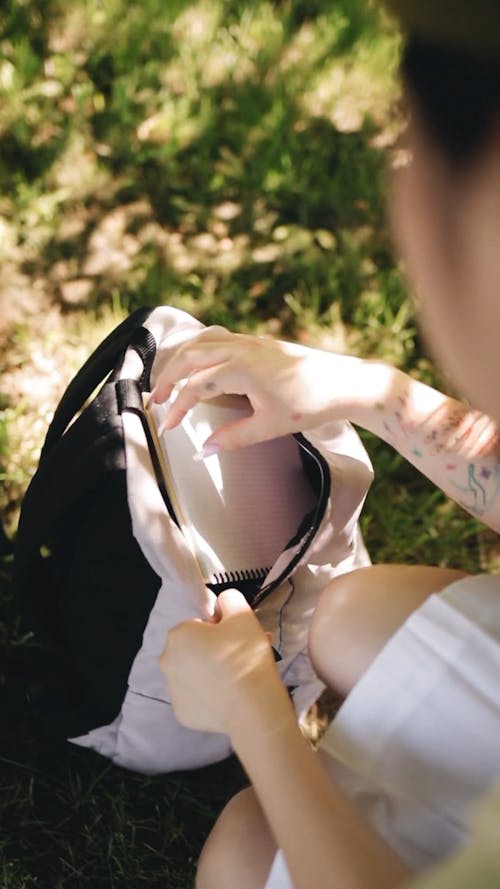 A Student Getting the Notebook from Her Bag