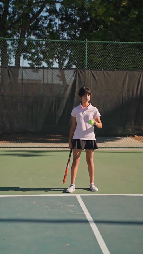 A Girl Serving The Ball In A Tennis Game