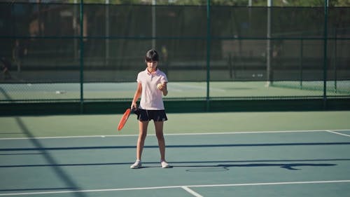 A Girl Playing A Game Of Tennis