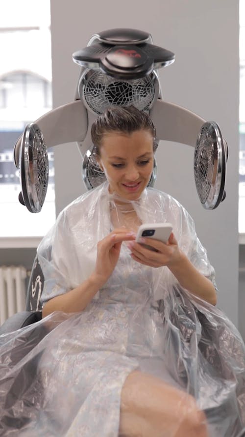 Woman Using Cellphone at a Hair Salon