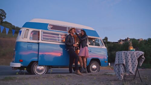 A Couple Talking Outside the Camper Van