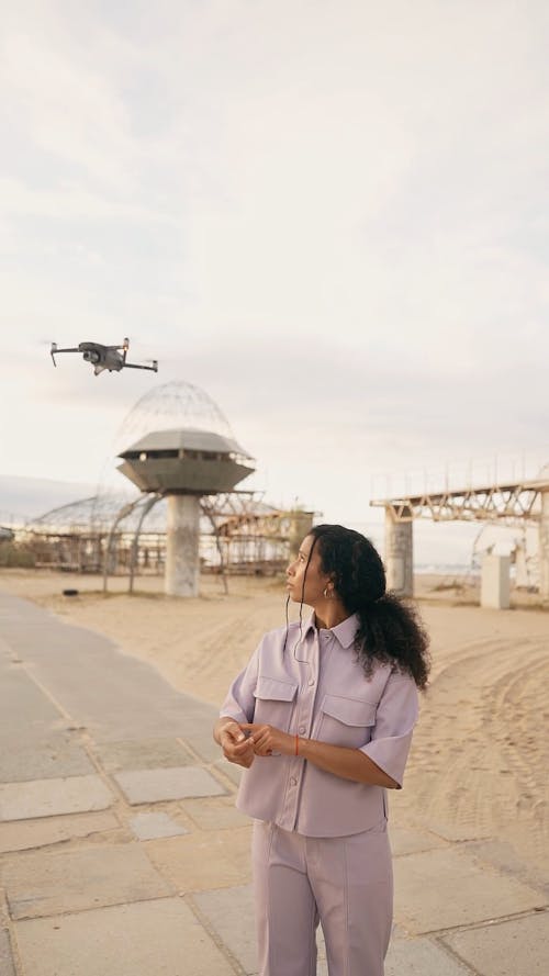 A Drone Flying Above a Woman