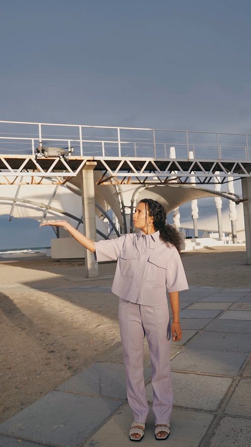 A Drone Flying Above a Woman