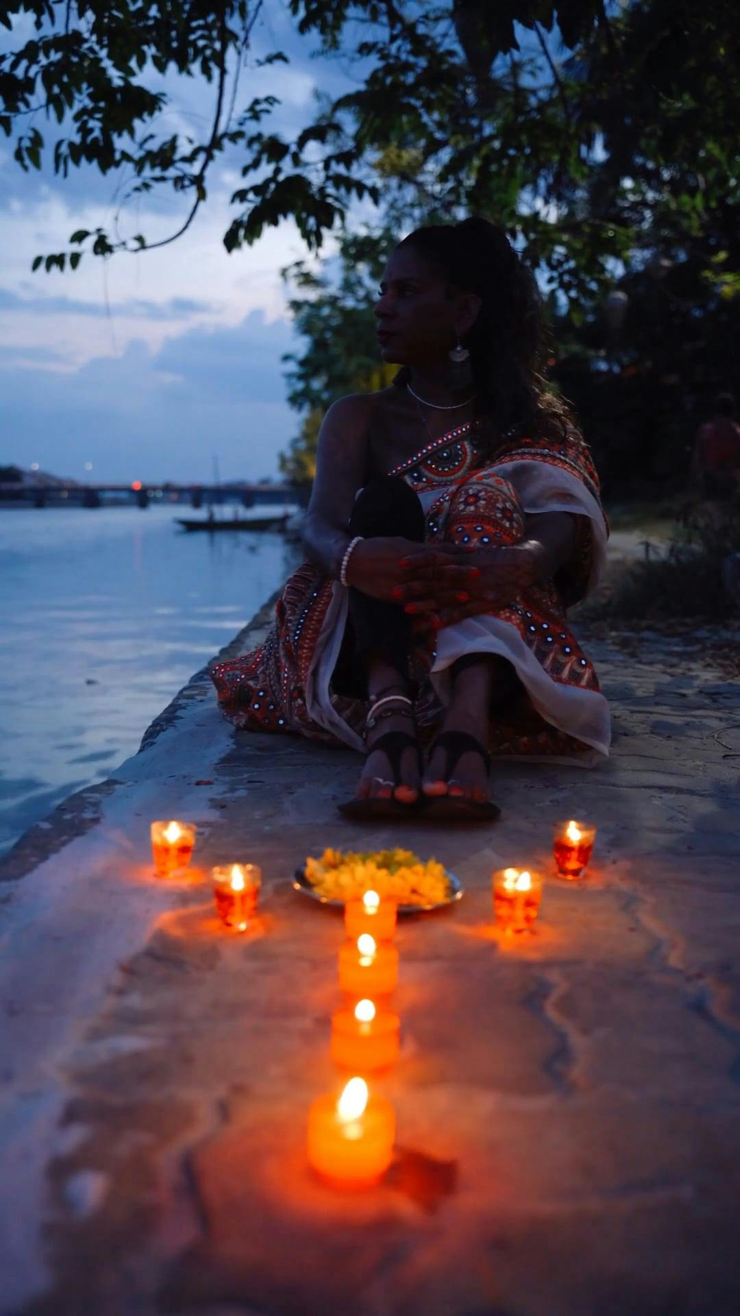 Young Woman Arranging Oil Lamps at a Diwali Festival