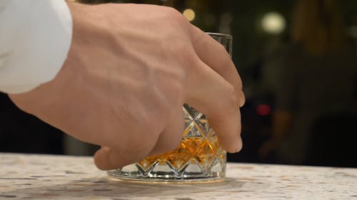 A Person Serving a Whiskey