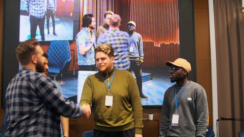 A Group of Men Receiving a Check at a Conference