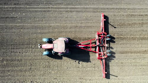 Aerial View of a Tractor Plowing the Land
