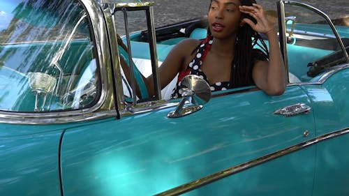 Woman Posing Inside A Classic Car