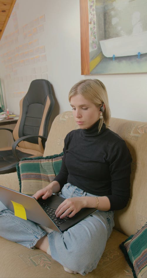 Woman In A Call While Typing On Computer