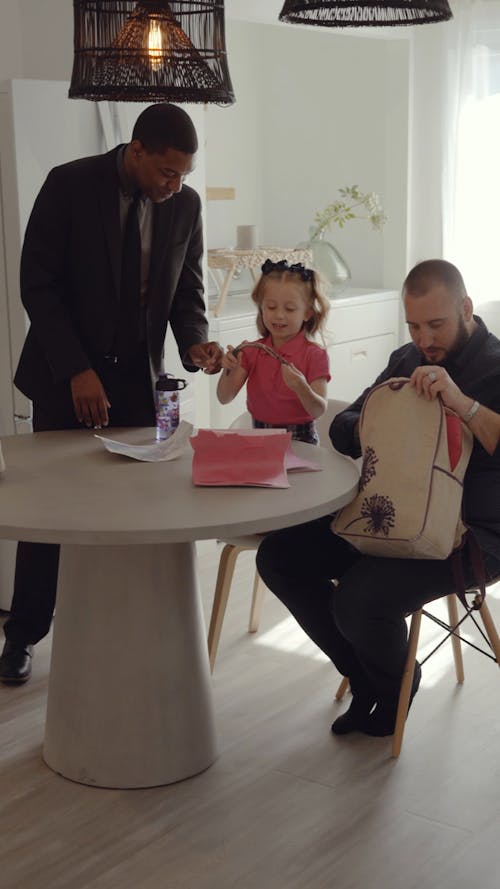 A Man Giving a Paper to his Daughter