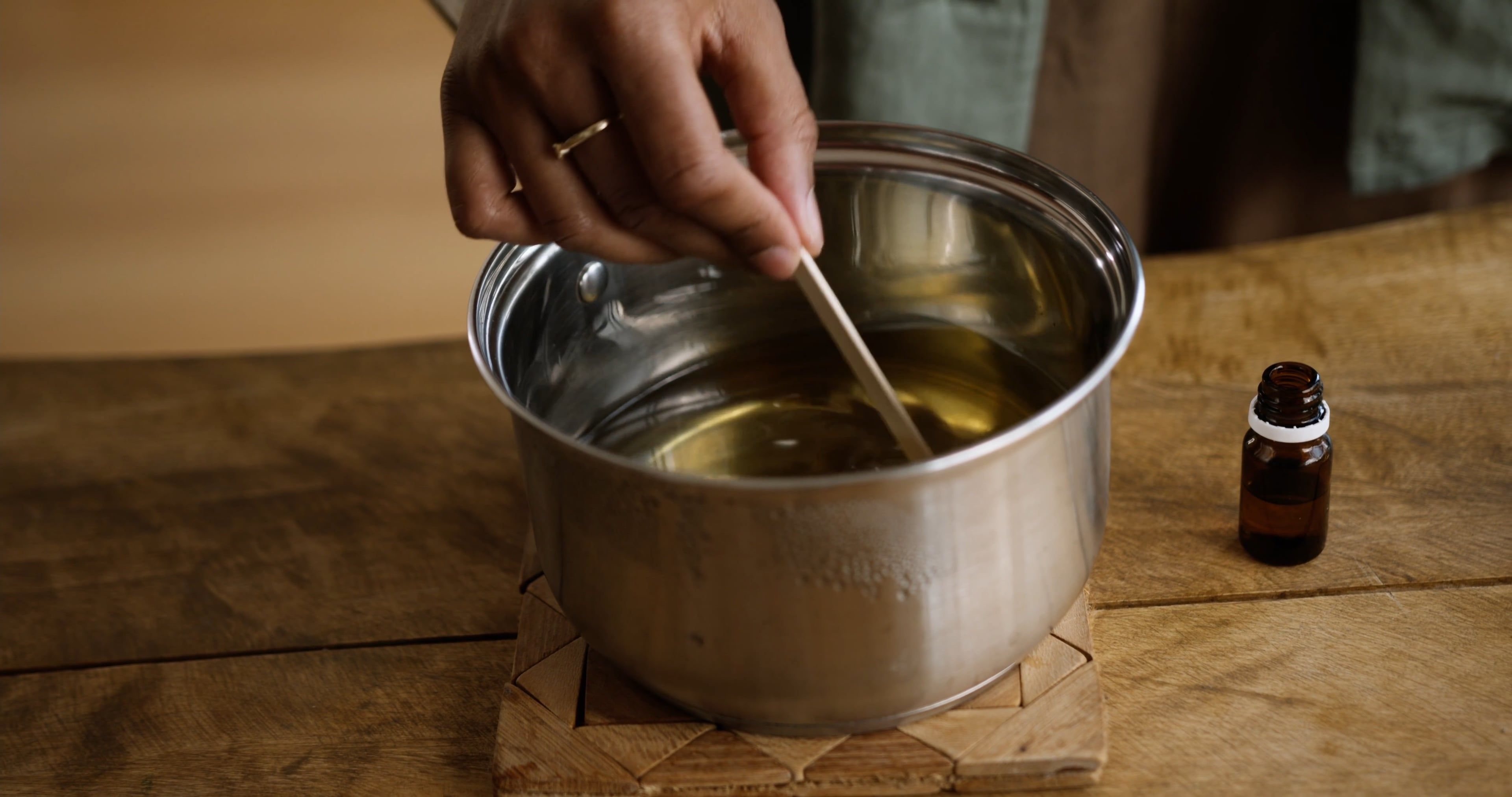 A Woman Smelling the Stick She Used in Stirring the Liquid on a Cooking ...
