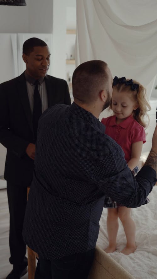 A Father Brushing the Hair and Dressing Up Her Daughter