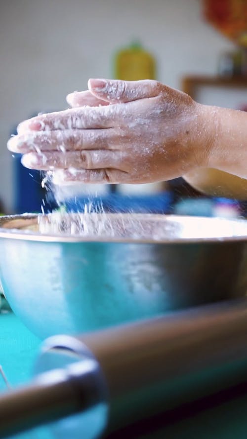 A Person Clapping Hands with Flour