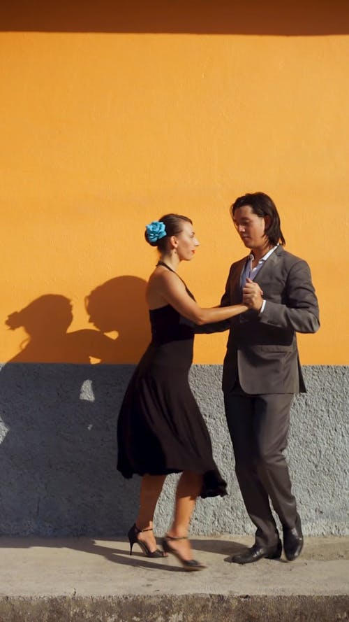 A Man and a Woman Dancing Under the Sun