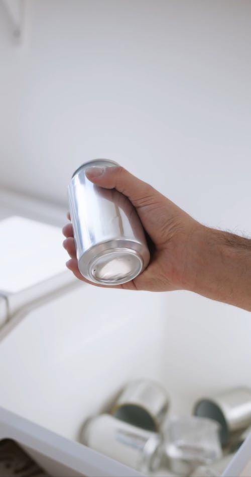 Person Crushing an Aluminum Can
