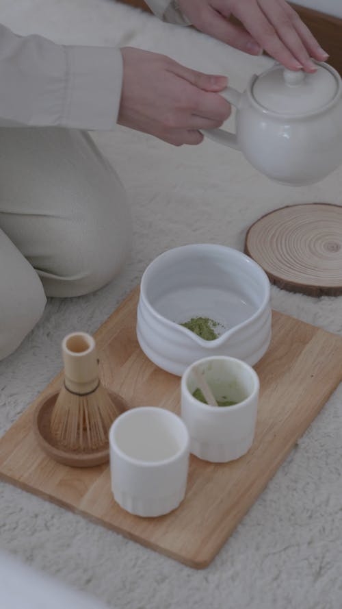 Woman Pouring Water on a Bowl