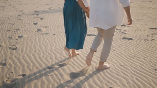 Barefoot Couple Walking on the Sand