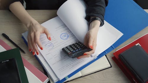 A Woman Using Calculator