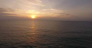 drone footage of a sunset at the ocean