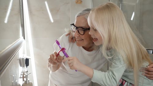 A Grandmother and a Granddaughter Playing with Their Toothbrushes
