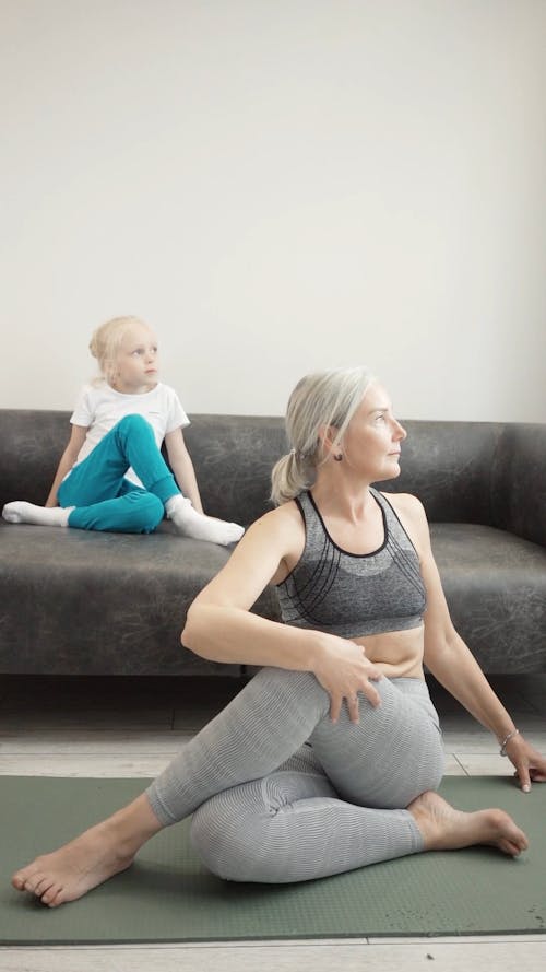 A Woman Doing Yoga with Granddaughter