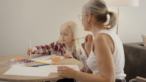 A Woman Painting with her Granddaughter