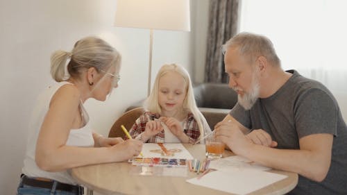 A Little Girl Painting with Grandparents