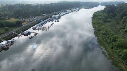 Aerial View of a River with Boats on the Side