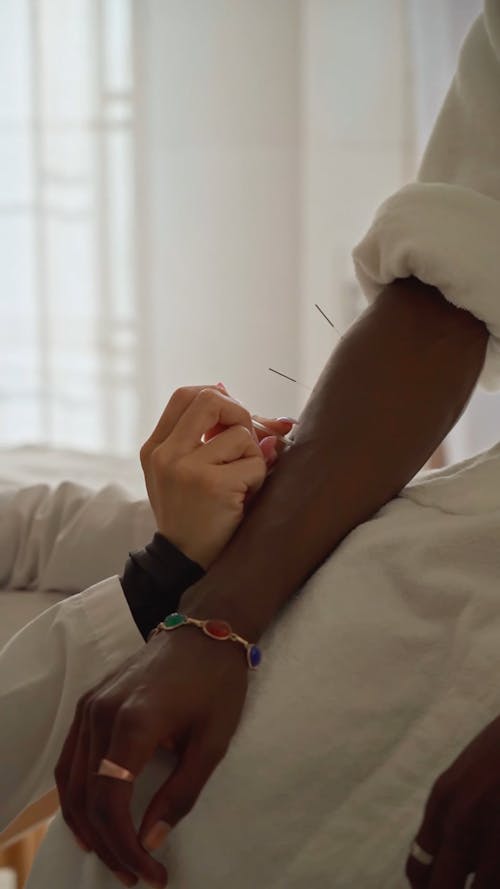 A Person Pricking Needles on the Arm