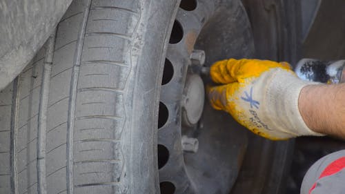 A Person Removing Tires