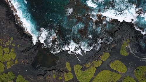 Top View of Waves Crashing on Coast