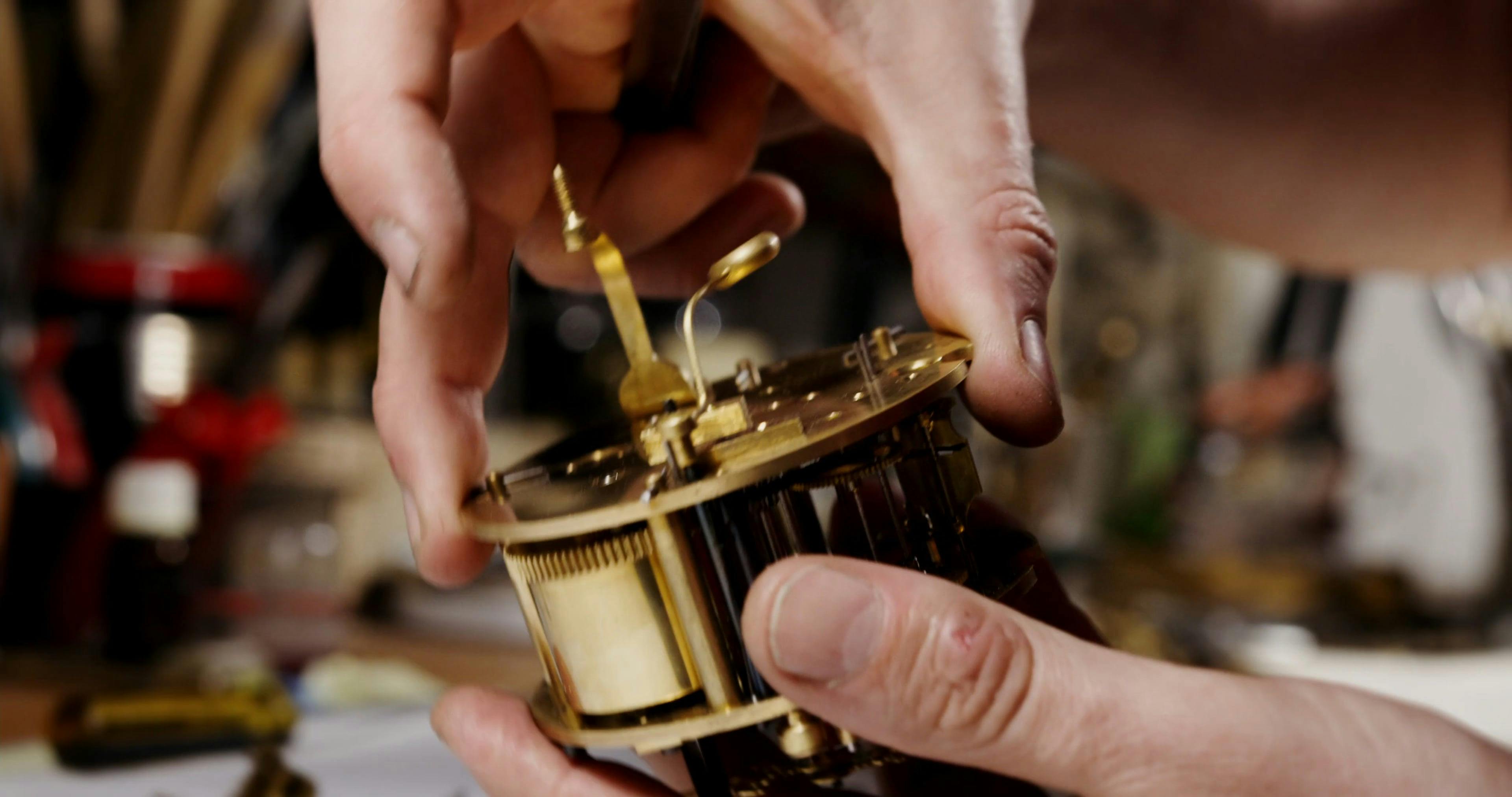 A Person Fixing the Components of a Vintage Clock · Free Stock Video