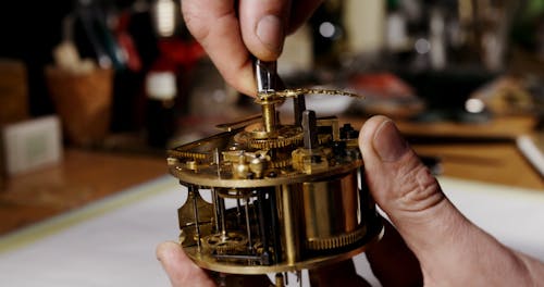 Person Repairing a Clock