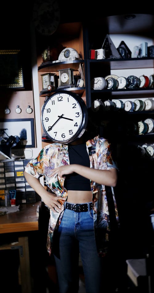 A Woman Dancing With a Wall Clock Covering Her Face