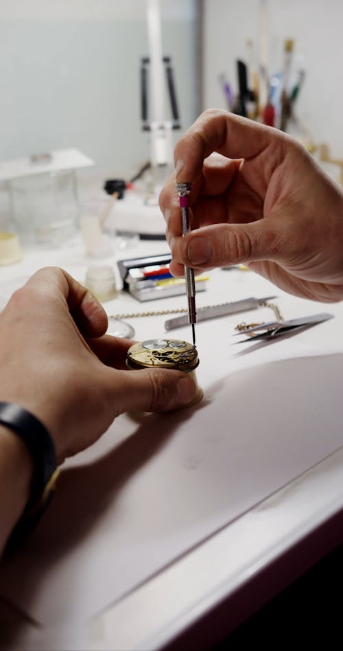 A Man Fixing a Pocket Watch