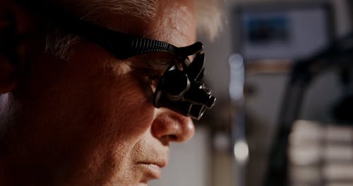 Elderly Man Wearing an Eyeglass Magnifier