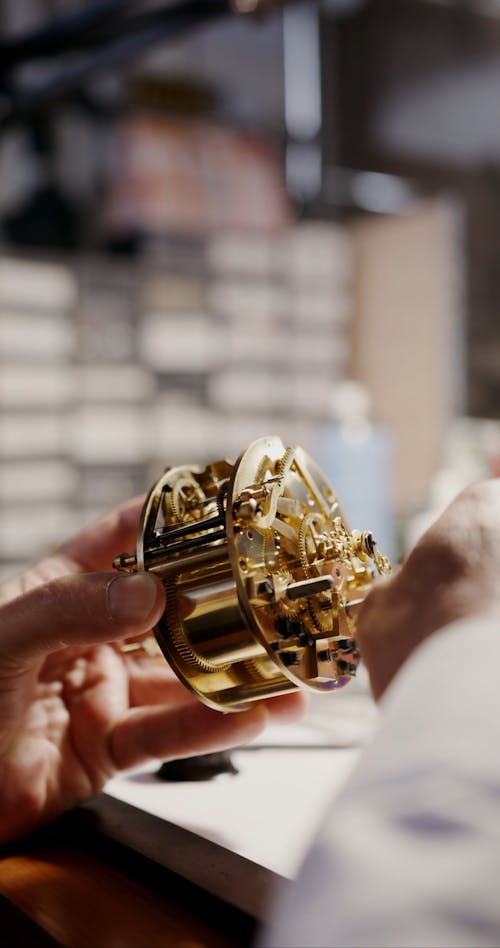 A Person Winding a Clock