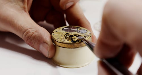 Person Repairing A Clock