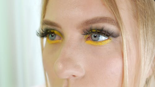 A Woman Wearing A Yellow Eyeliner