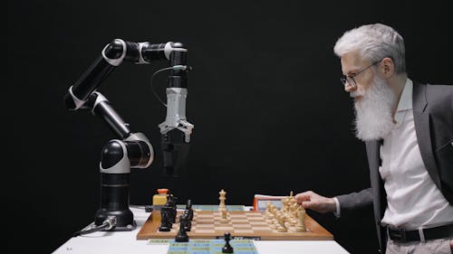 Elderly Man Playing Chess with a Robot