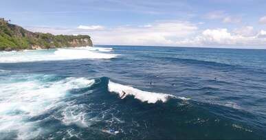 a person surfing on the beach