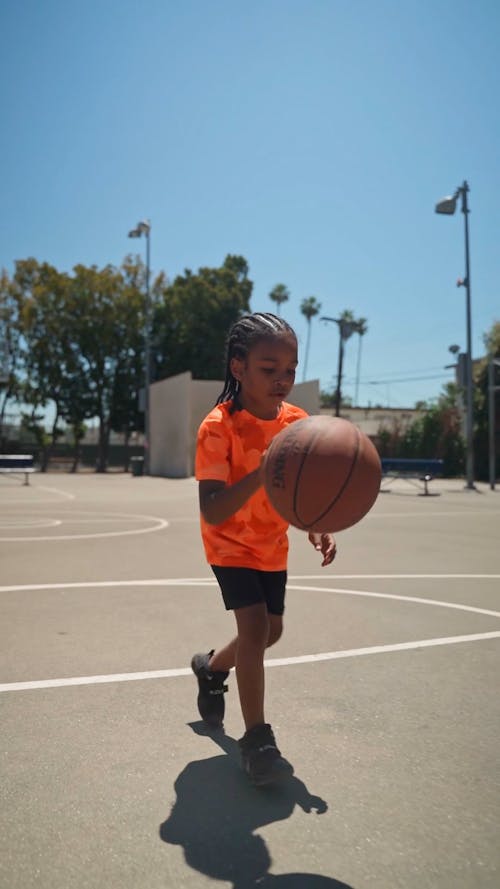 A Little Boy Shooting a Basketball