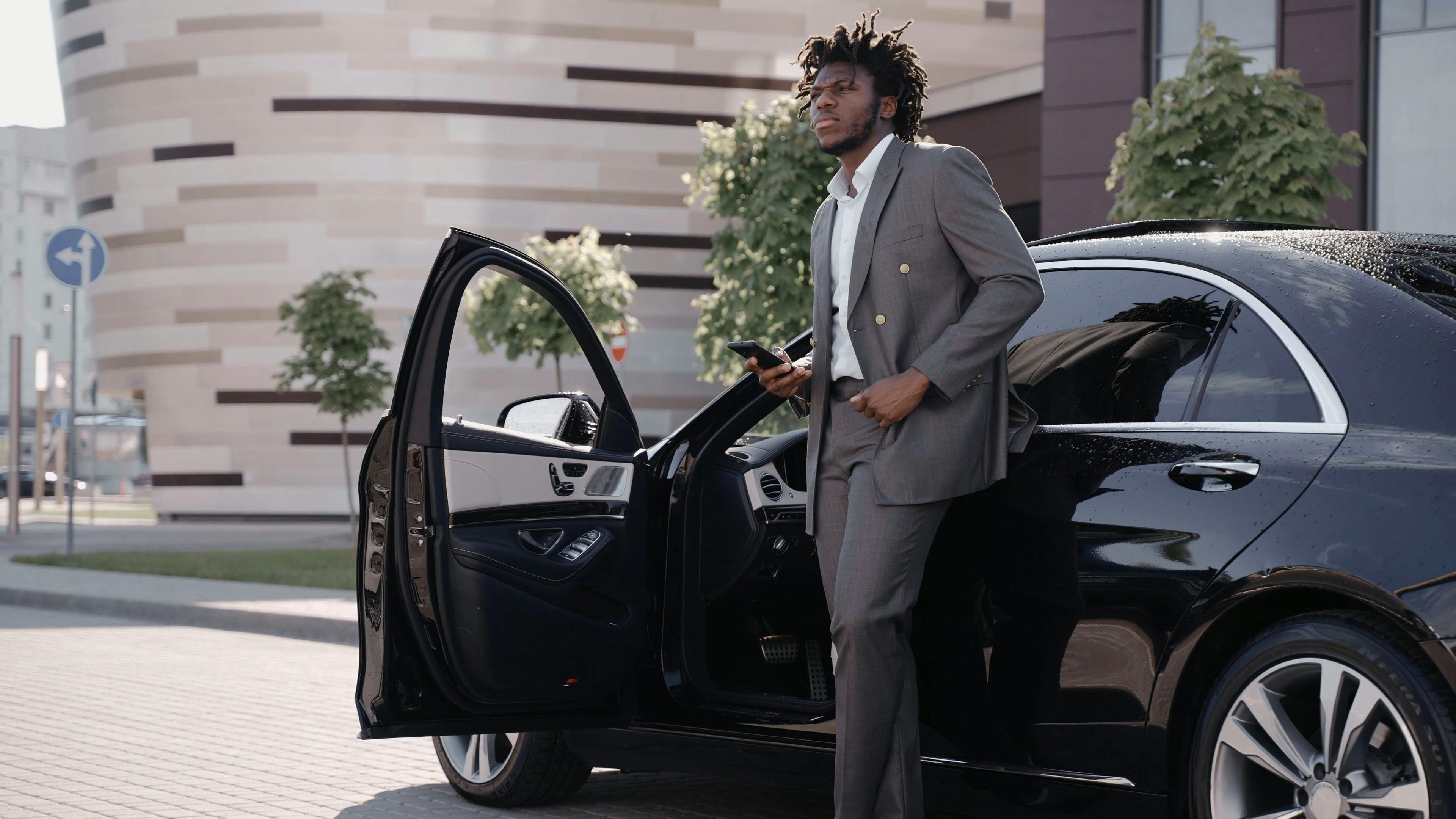 Man Wearing a Gray Suit Waiting Outside His Car · Free Stock Video
