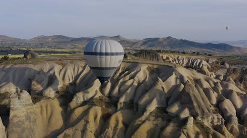 Aerial View of a Hot Air Balloon Floating Above the Natural Rock Formation